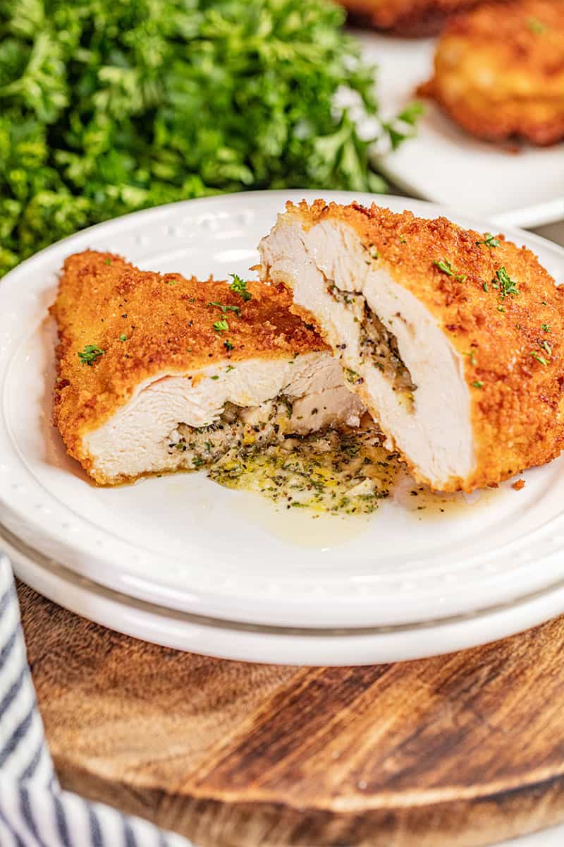 Chicken Kiev cut in half with compound butter spilling out.