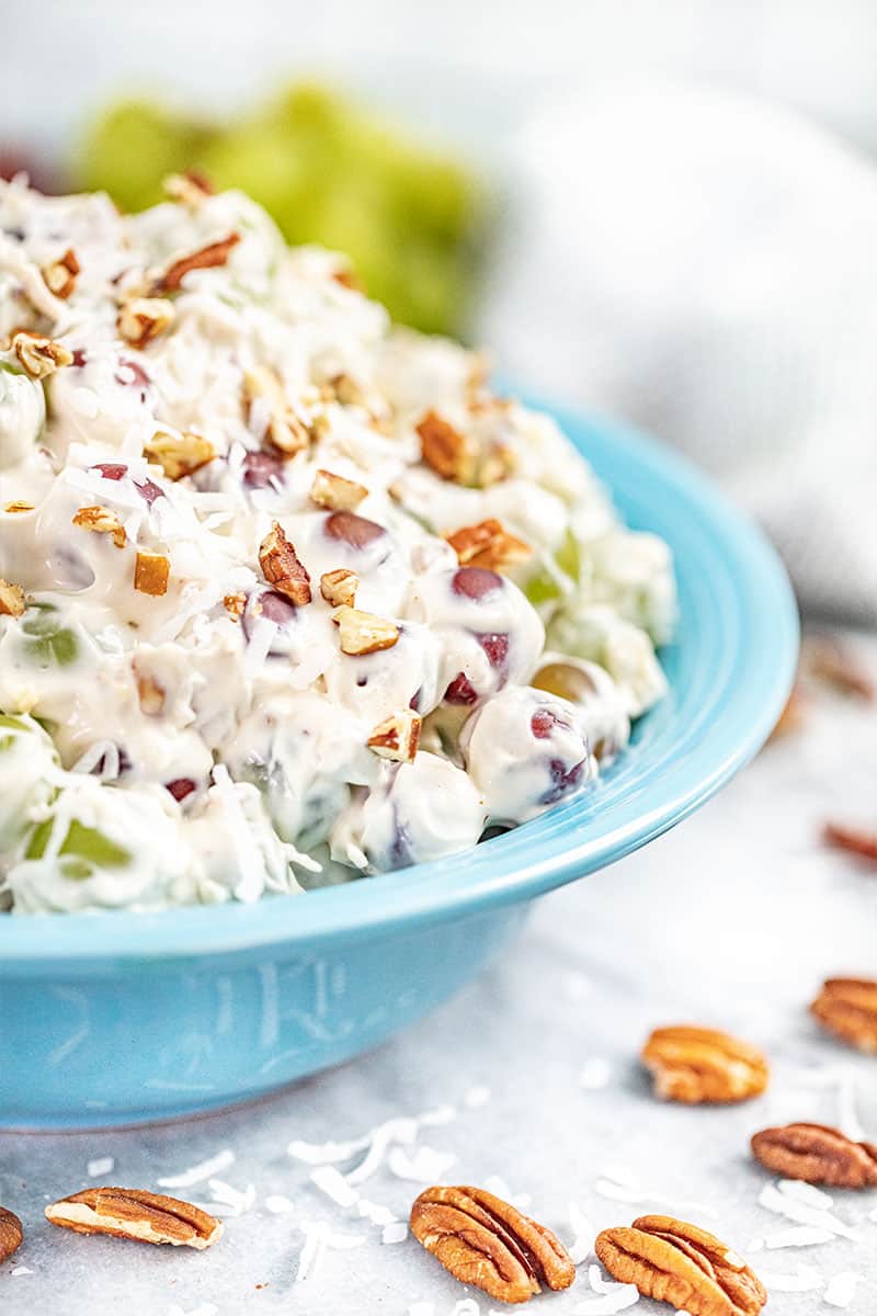 Creamy grape salad in a large blue bowl.