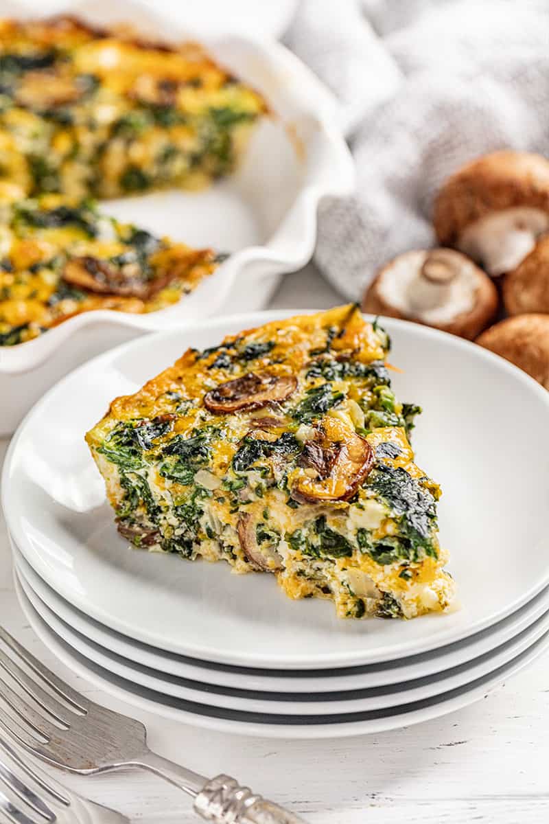 A piece of crustless spinach quiche on a plate.