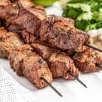 Marinated beef kabobs on a platter.