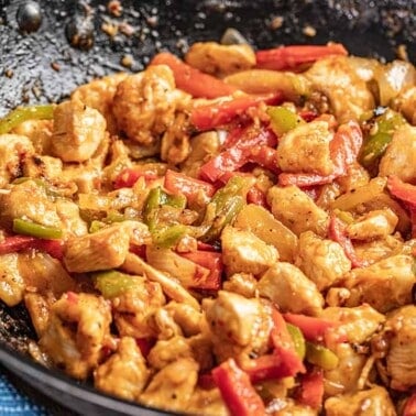 Close up view of szechuan chicken in a wok.