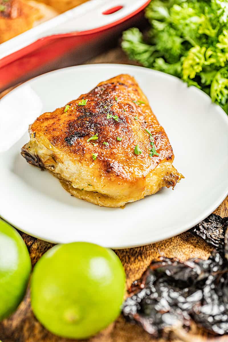 Chipotle and lime chicken thigh on a white plate.