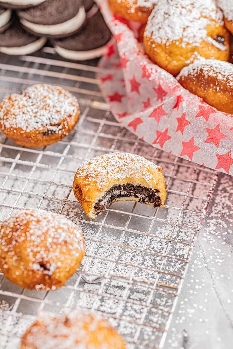 Deep fried Oreos with a bite taken out.