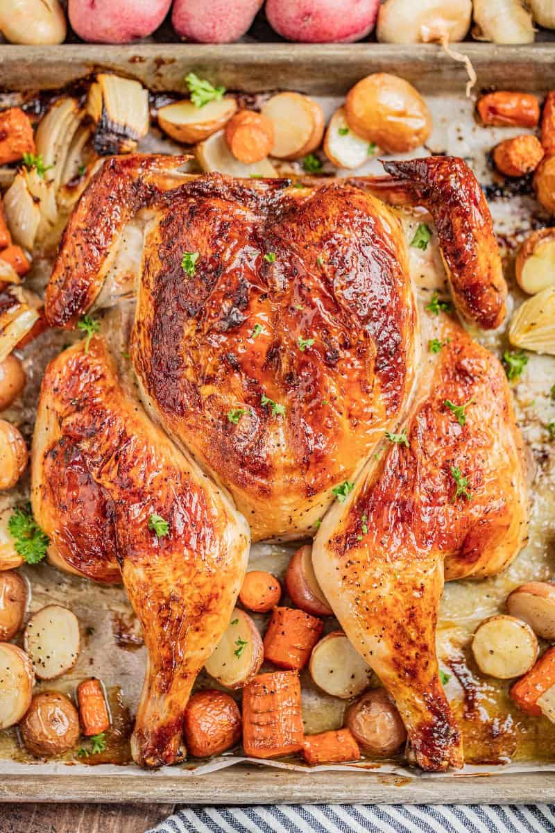 Overhead view of spatchcock chicken on a baking sheet.