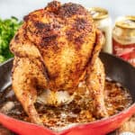Roasted beer can chicken in a skillet.