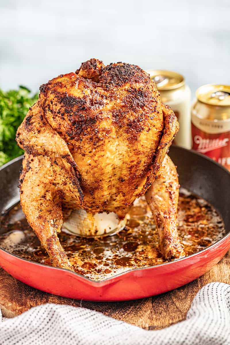 Roasted beer can chicken in a skillet.