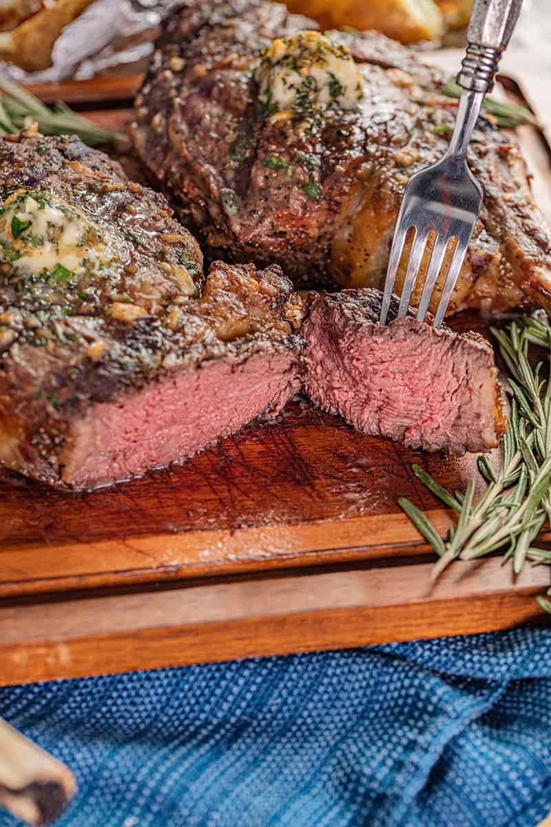 Tomahawk steak cut open to show cooked to medium-rare.