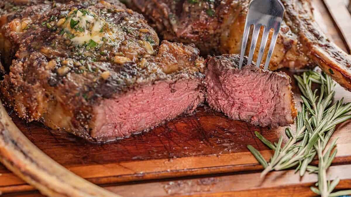 Perfect tomahawk steak cut open and cooked to medium-rare.