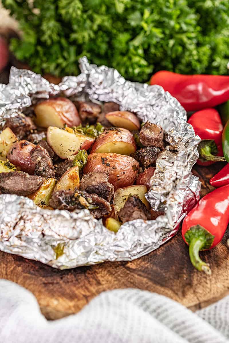 Steak and potatoes in a foil packet.