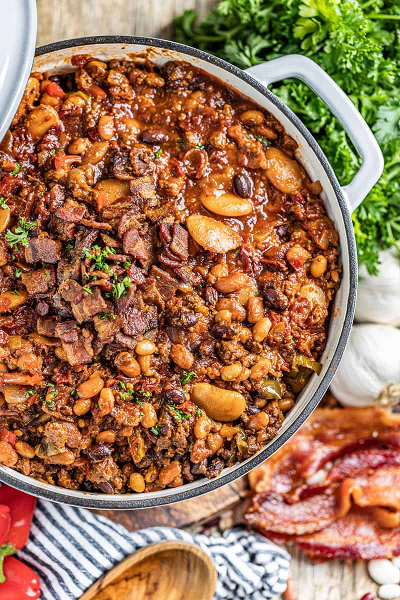 Overhead view of country style baked beans in a saucepan.