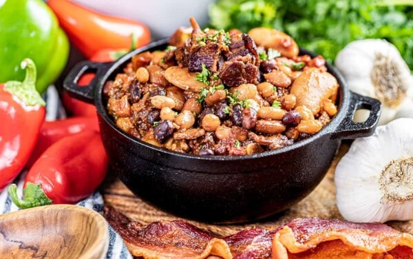 Country style baked beans in a small black bowl.