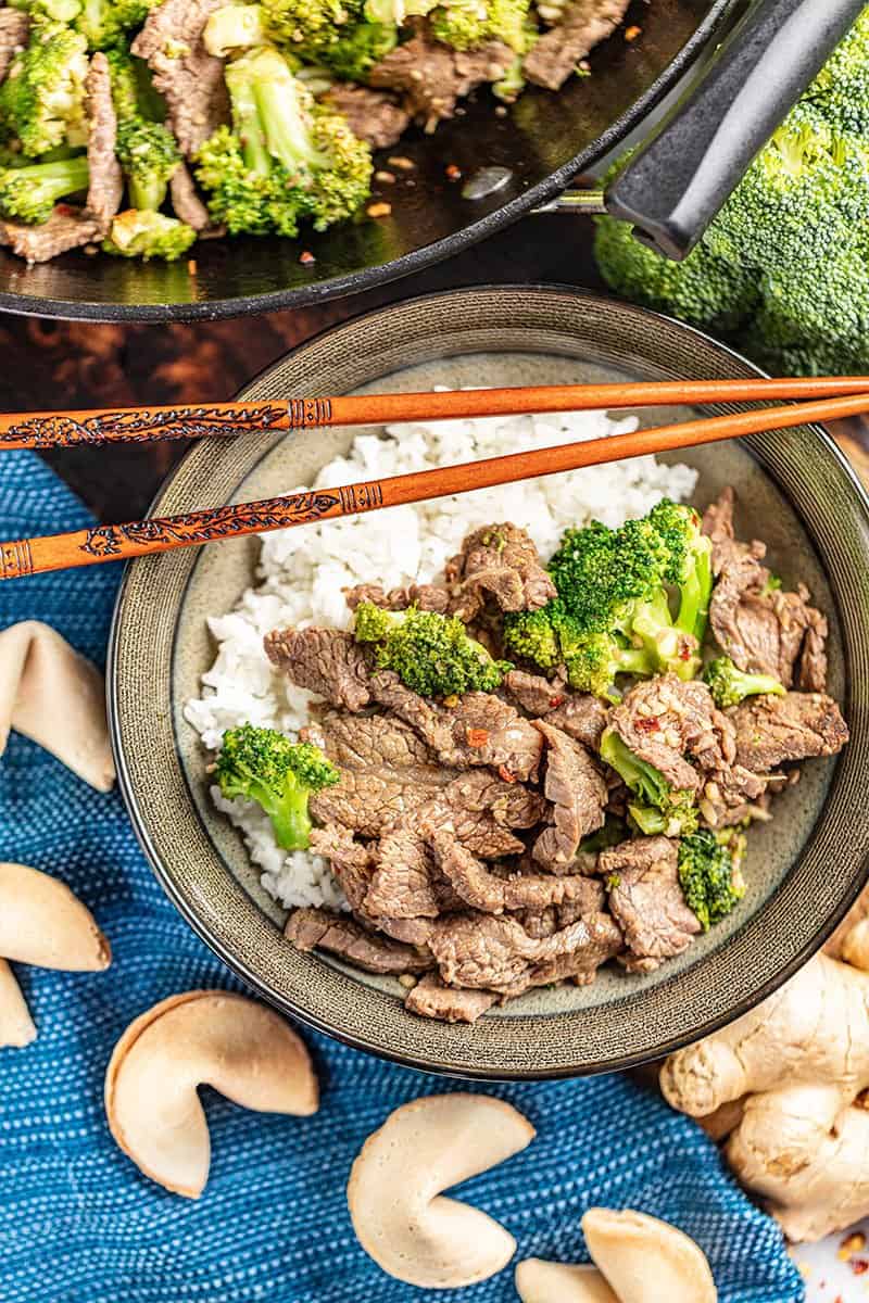 Overhead view of a bowl fill with takeout style beef and broccoli and white rice.