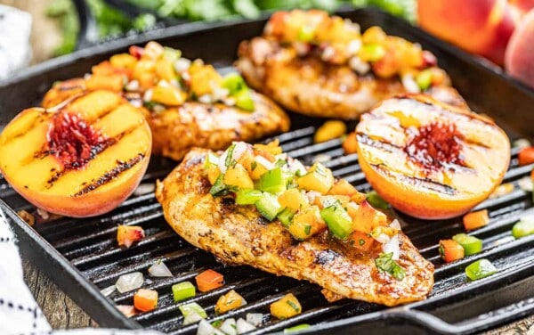 Chipotle peach glazed grilled chicken breasts on a grill pan.