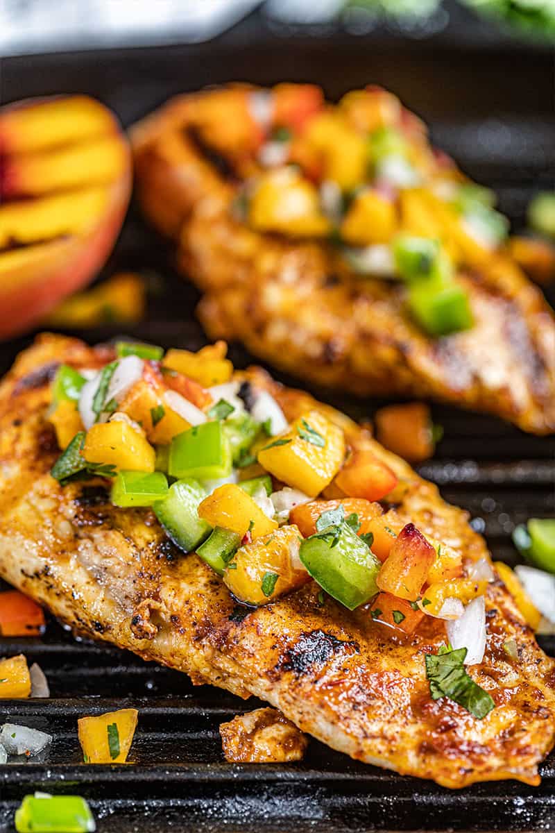 Close up view of a chipotle peach glazed grilled chicken breast.