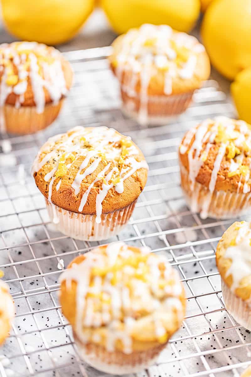 Lemon poppyseed muffins on a cooling rack.