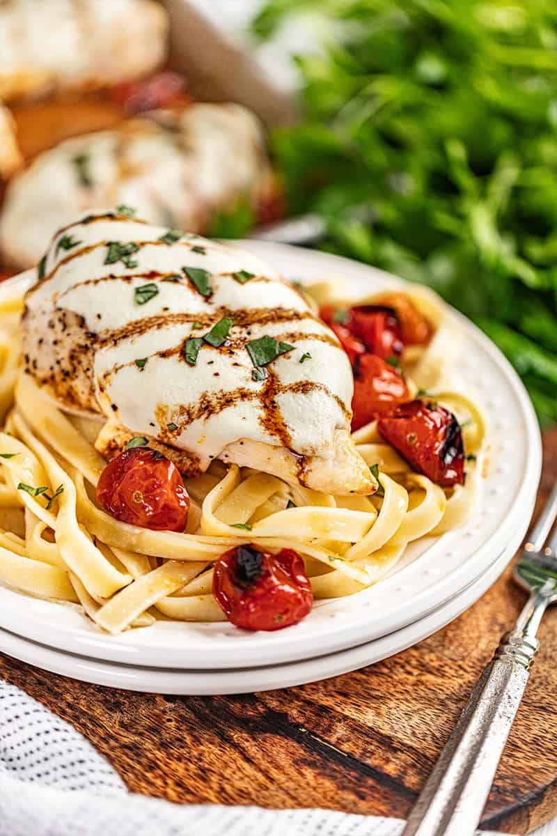 Sheet pan chicken caprese on a dinner plate.