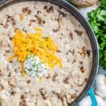 Overhead view into a large pot filled with creamy sausage potato soup.