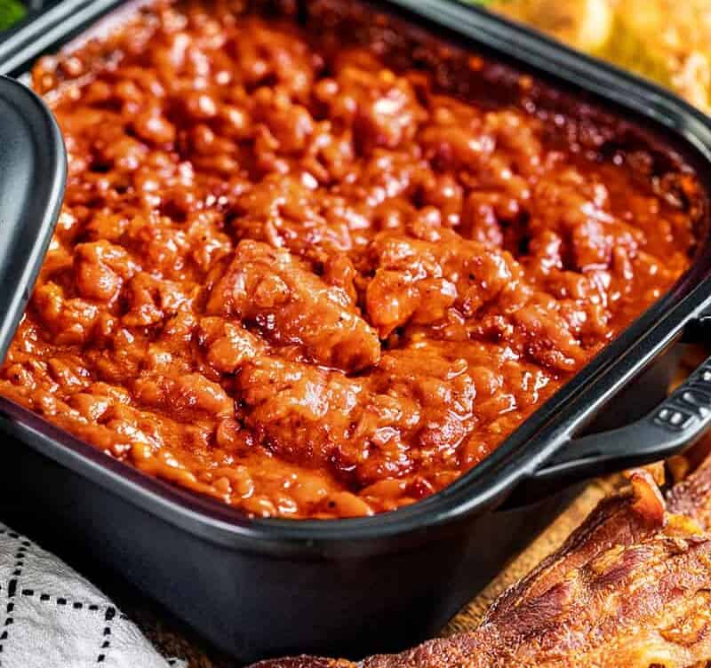 Homemade pork and beans in a square dish.