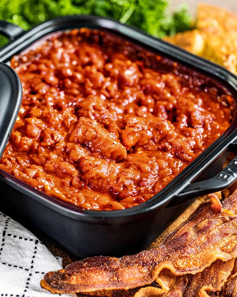 Homemade pork and beans in a square dish.