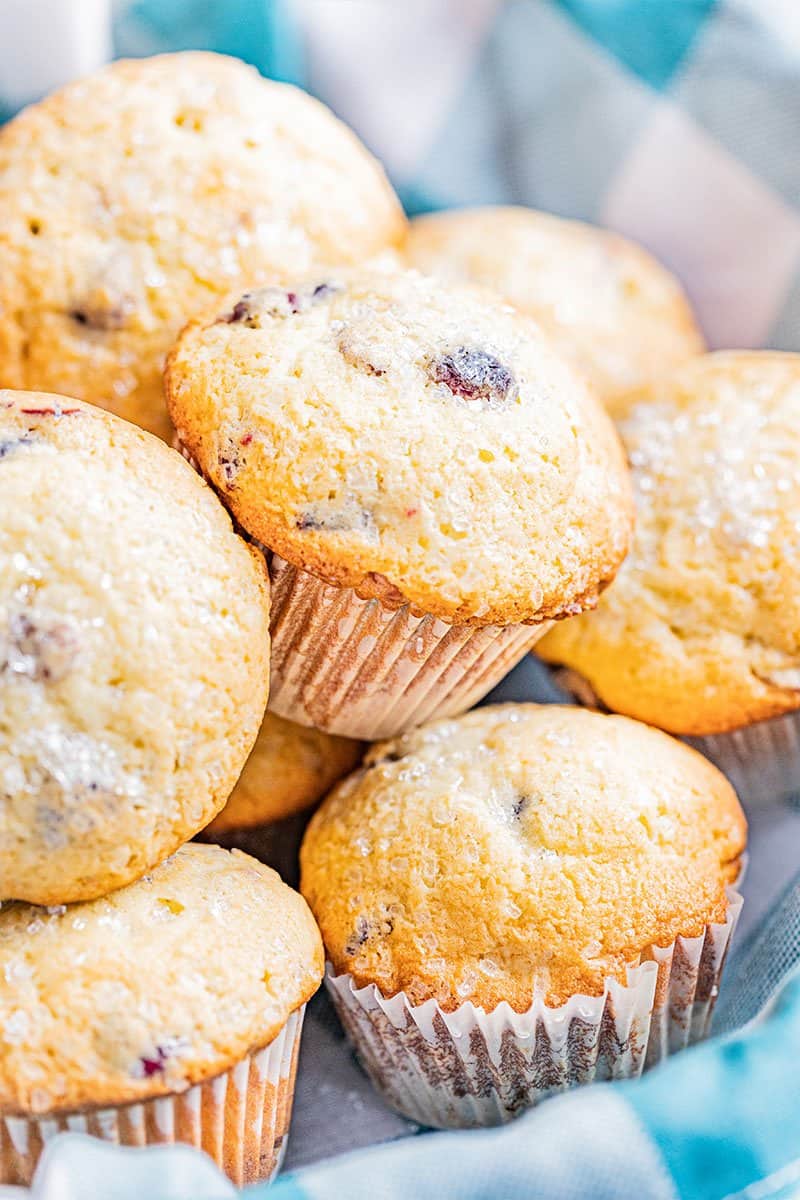 Orange cranberry muffins in a basket.