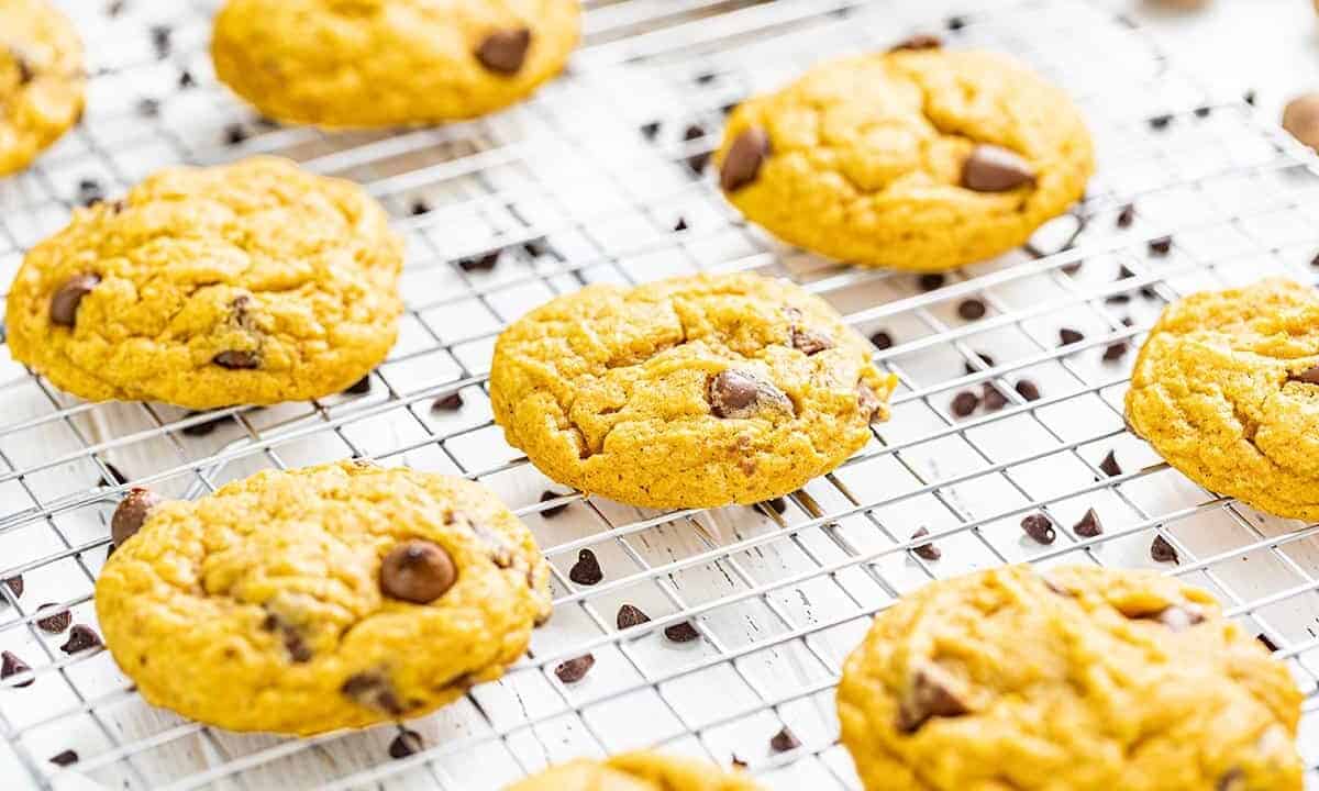 Pumpkin chocolate chip cookies on a cooling rack.