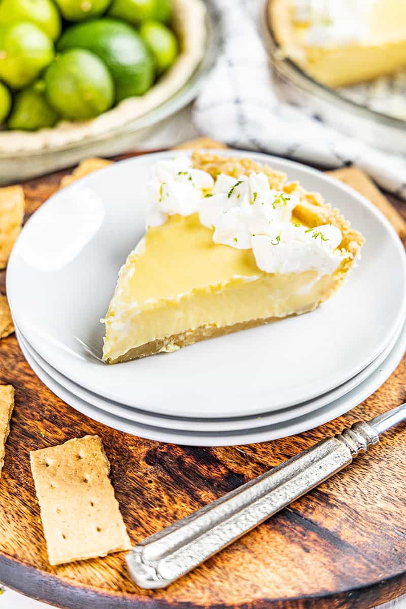 A slice of key lime pie with homemade whipped cream.