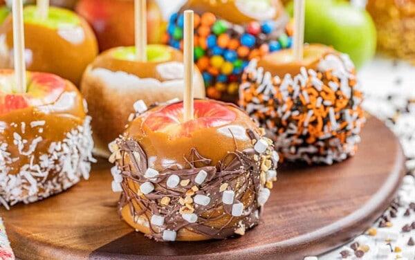 Close up view of caramel apples with various toppings.