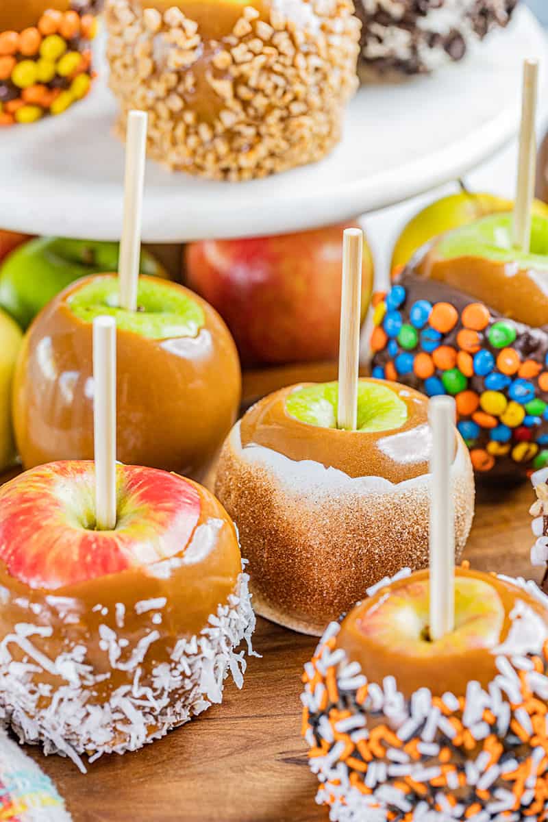 Homemade caramel apples with various toppings.