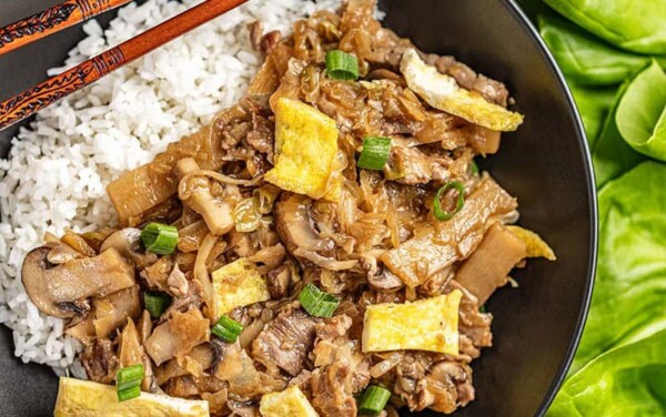 Overhead view of moo shu pork and white rice in a bowl.