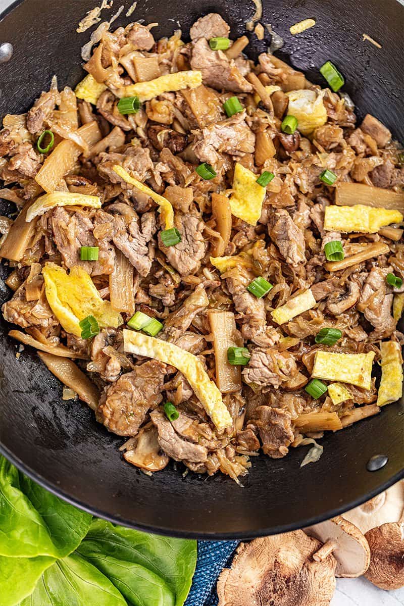 Overhead view of moo shu pork in a wok.