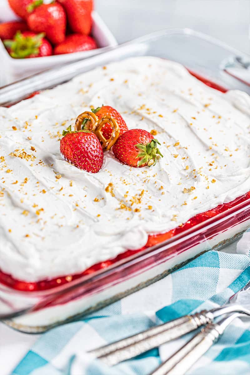 Strawberry pretzel salad in a glass dish.