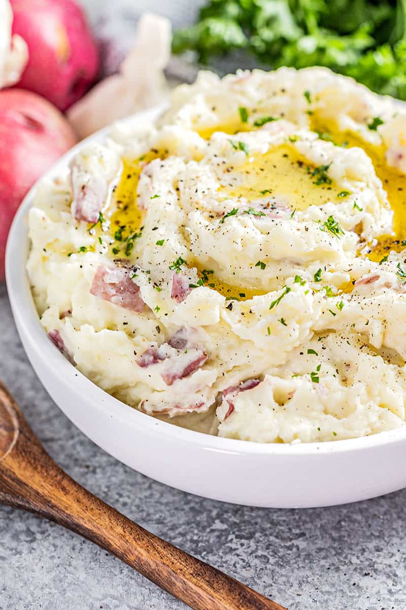 Steakhouse style garlic mashed potatoes in a large white bowl.
