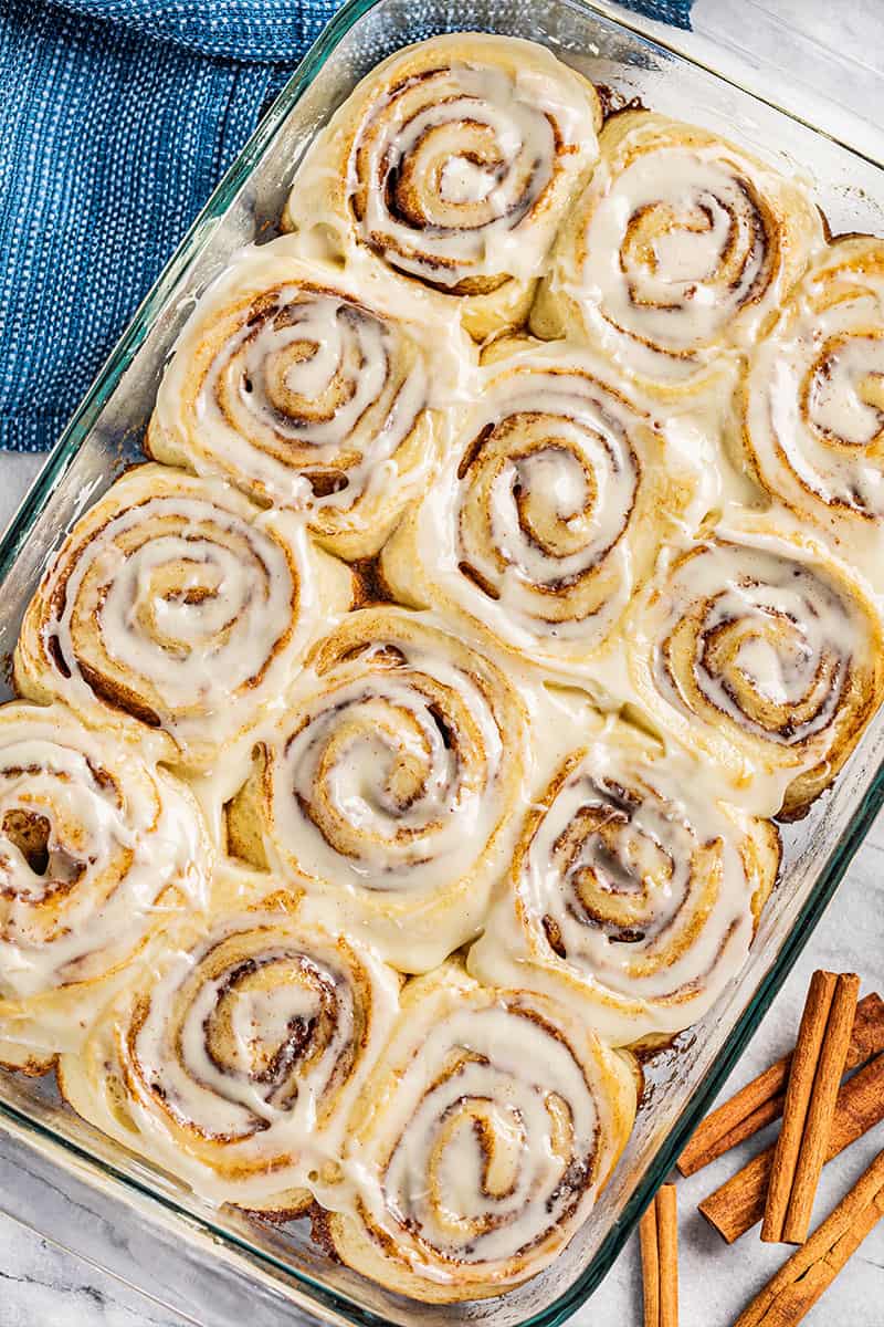 Overhead view of cinnamon rolls in a glass baking dish.