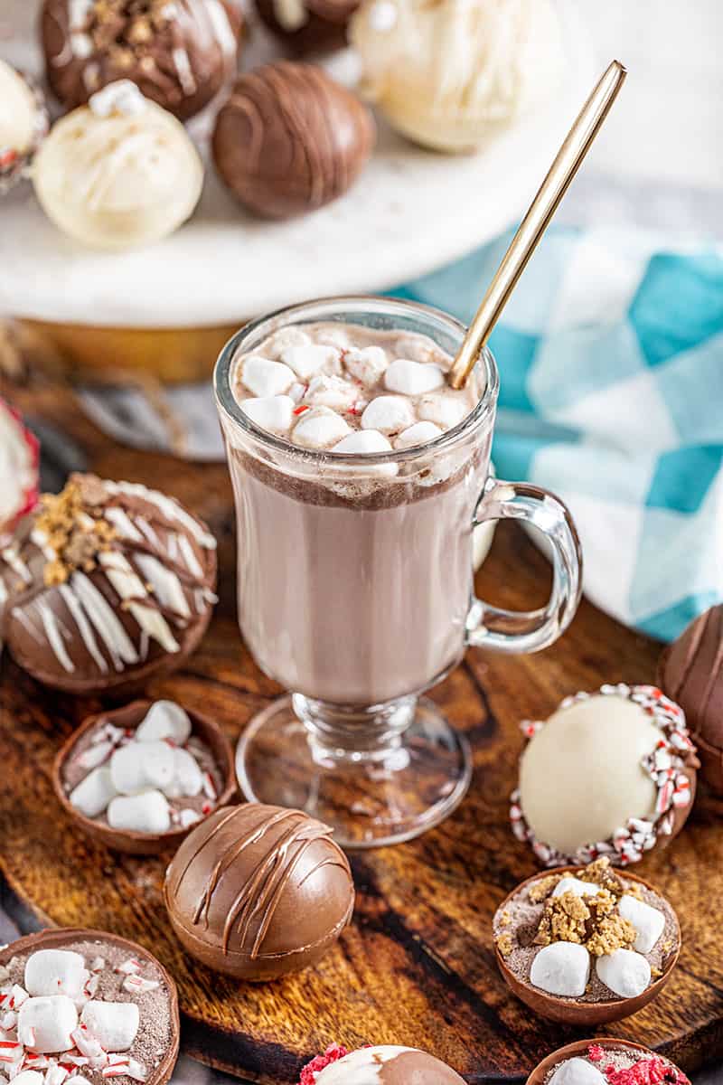 A glass mug filled with hot chocolate from a hot chocolate bomb.