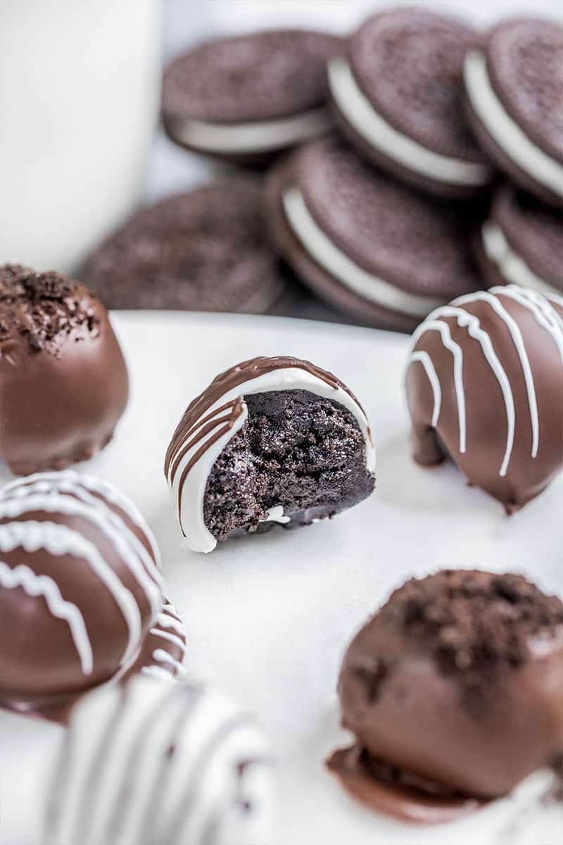 Oreo truffles with a bite taken out.