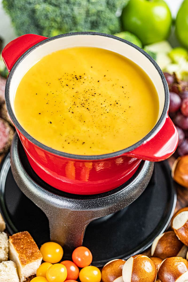 A fondue pot filled with cheese fondue.