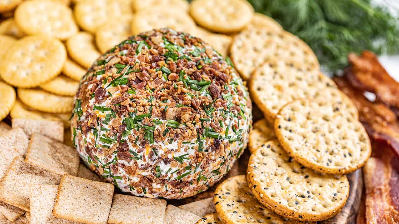 Close up view of a cheeseball with crackers.
