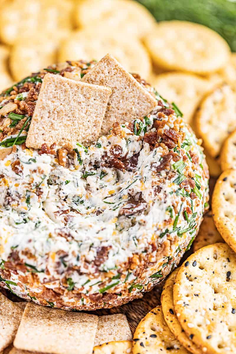 Close up view of a cheeseball with crackers.