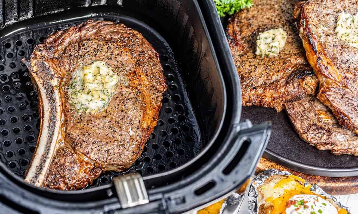 Overhead view of a cooked steak in an air fryer.