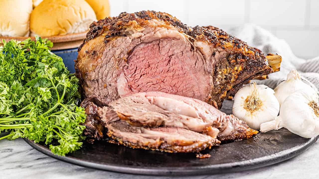 Chef de-boning and carving a portion of barbecued prime rib steak