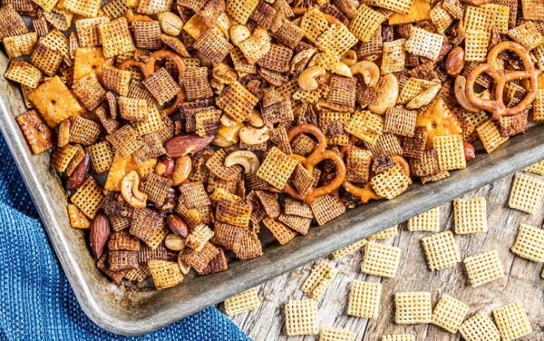 Overhead view of party Chex mix on a baking sheet.