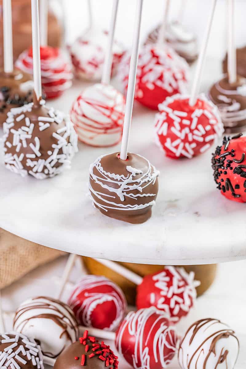 Cake pops on a cake stand.