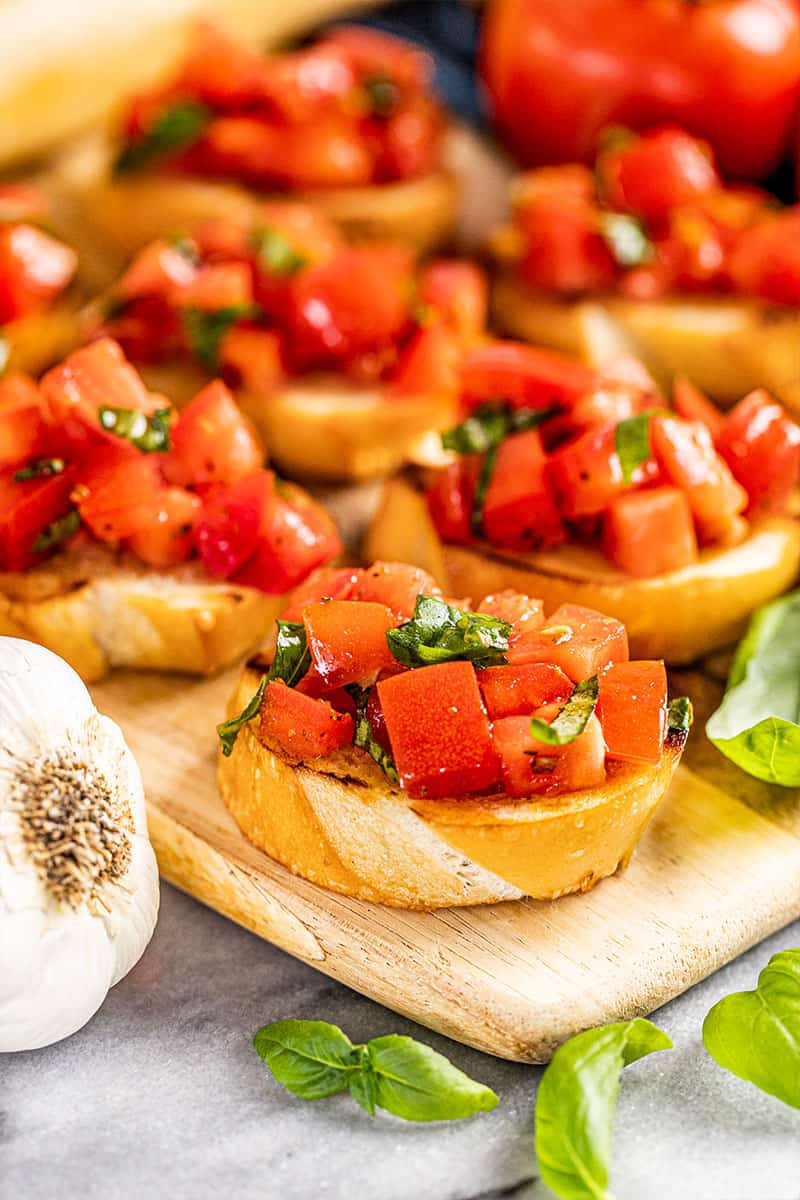 Bruschetta on a wood serving tray.