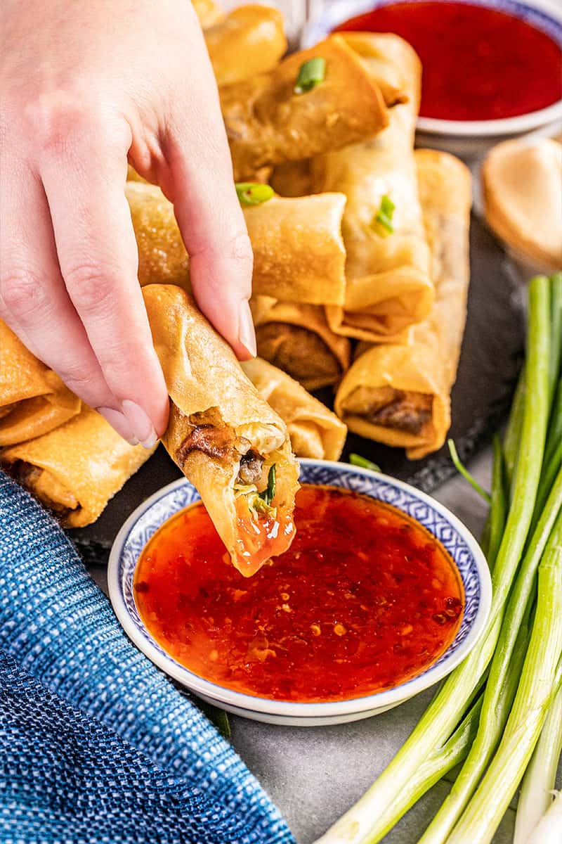 A crispy spring roll dipped in sweet chili sauce.