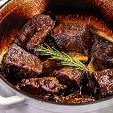 Looking into a stockpot filled with braised beef short ribs.