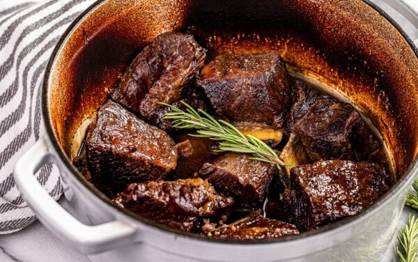 Looking into a stockpot filled with braised beef short ribs.