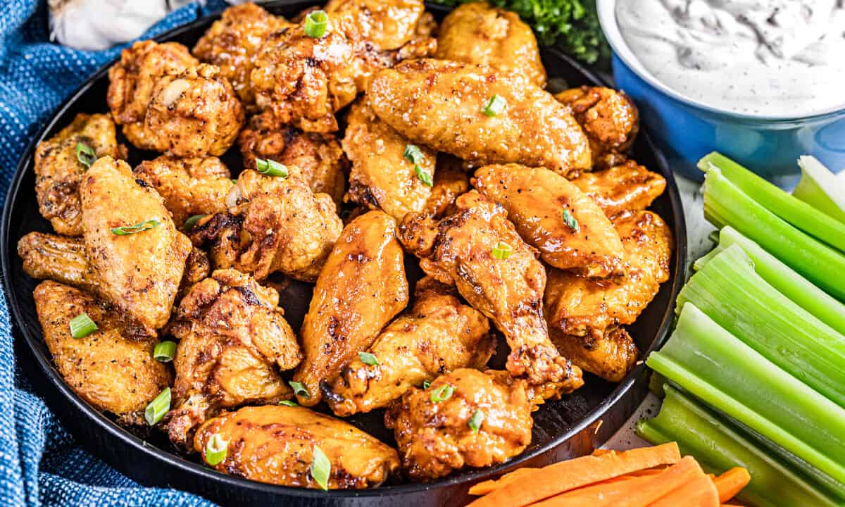 A black bowl filled with air fryer chicken wings.