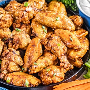 A black bowl filled with air fryer chicken wings.