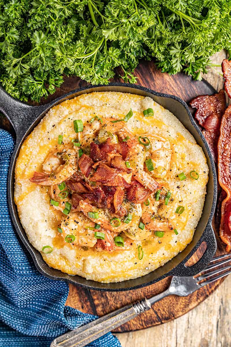 Overhead view of shrimp and grits in a pan.