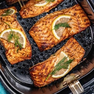 Overhead view of salmon looking into an air fryer.